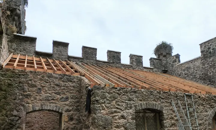 Reroofing work in progress on a large building