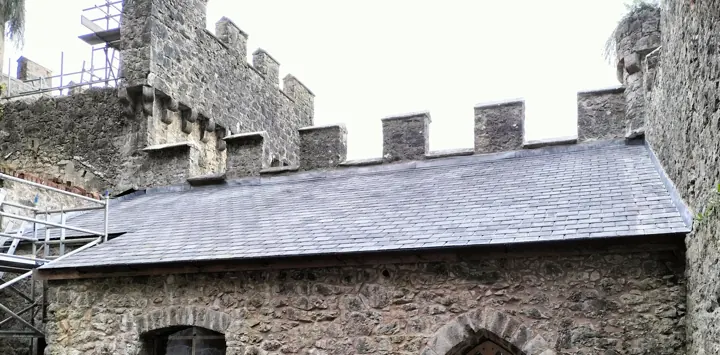 Traditional slate roof work on a dairy building